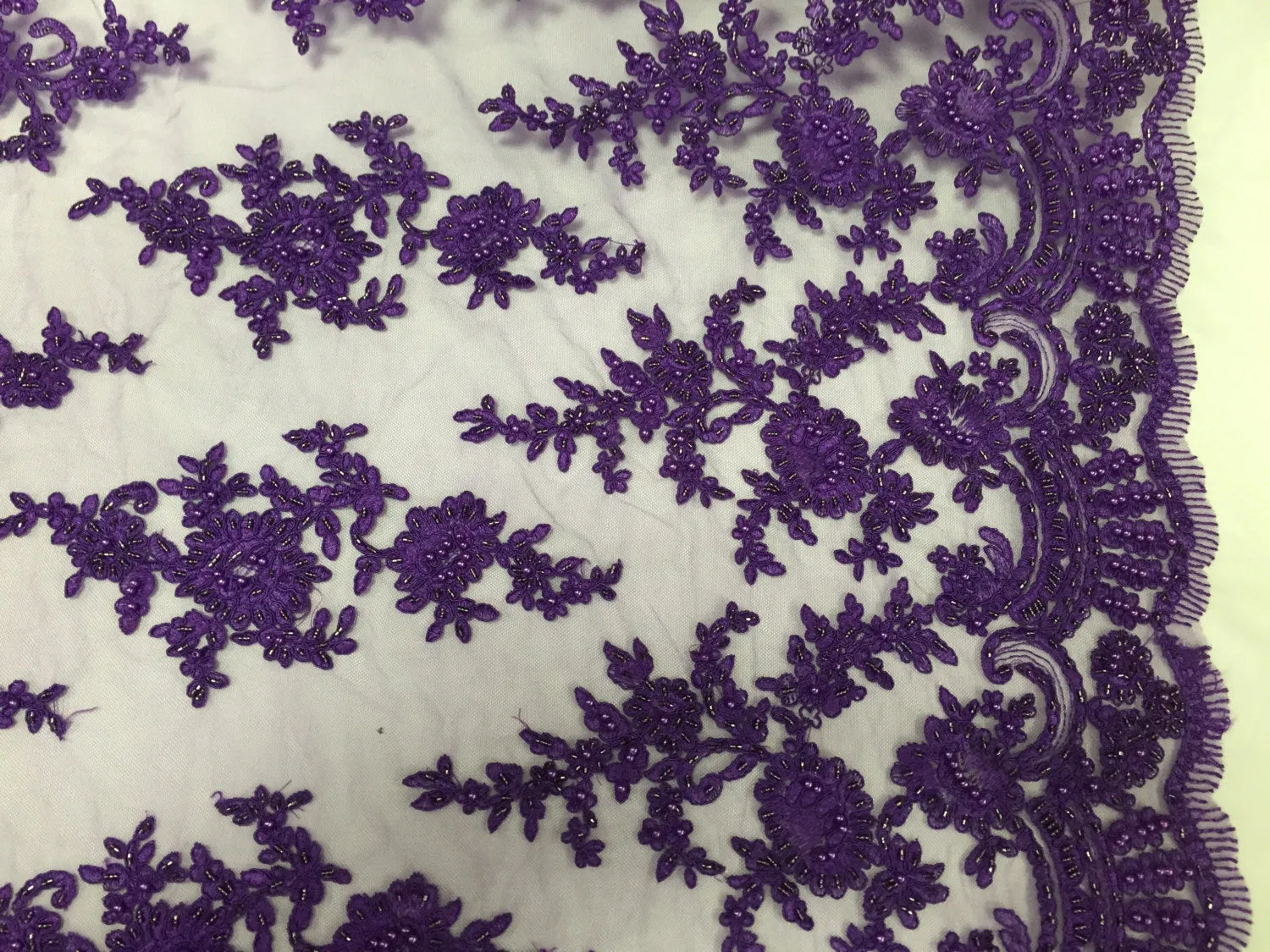 Purple appealing flower design embroider and beaded on a mesh lace-prom-nightgown-decorations-dresses-sold by the yard.