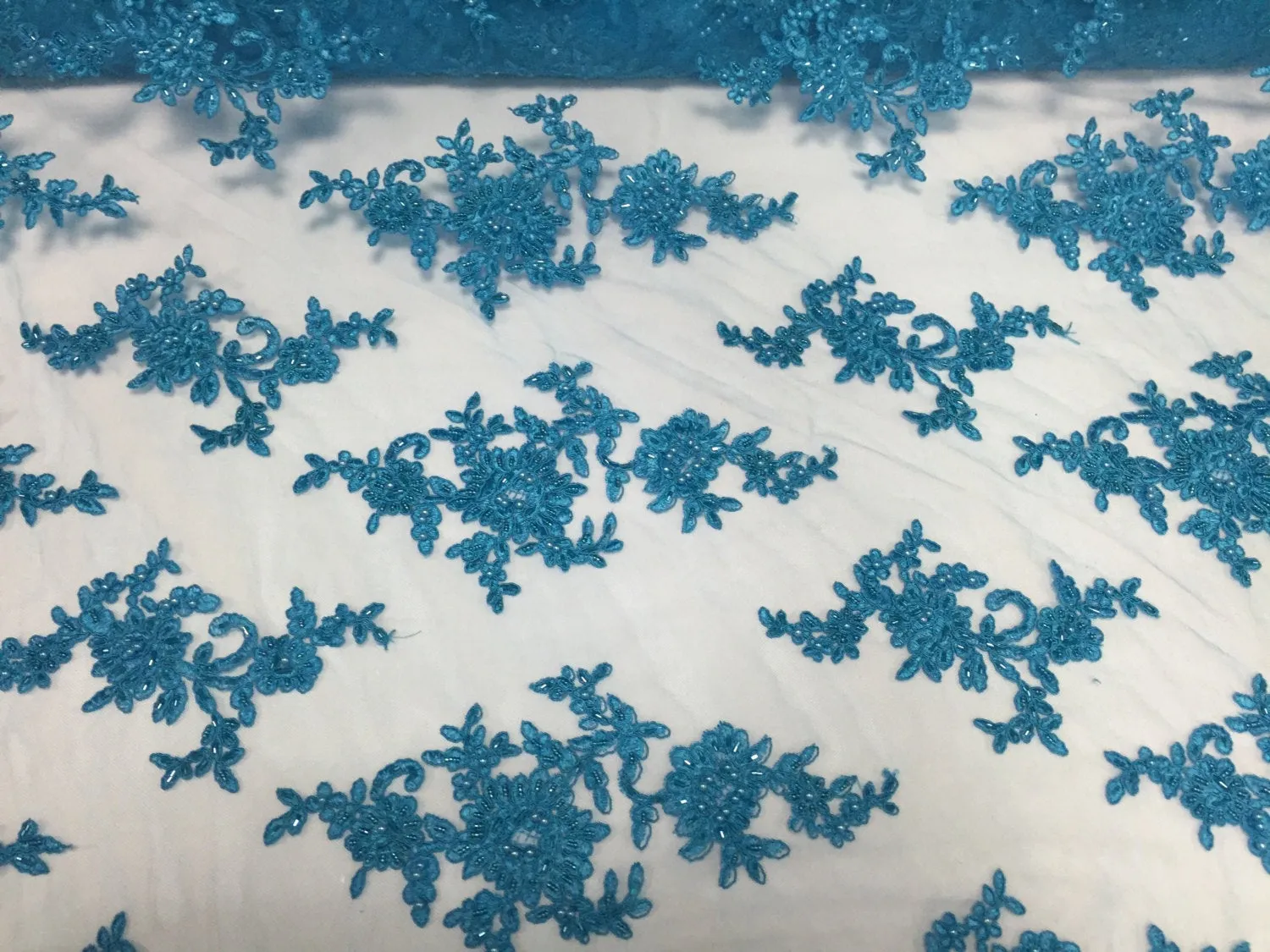 Turquoise appwaling flower design emboider and beaded on a mesh lace-prom-nightgown-decorations-dresses-sold by the yard.