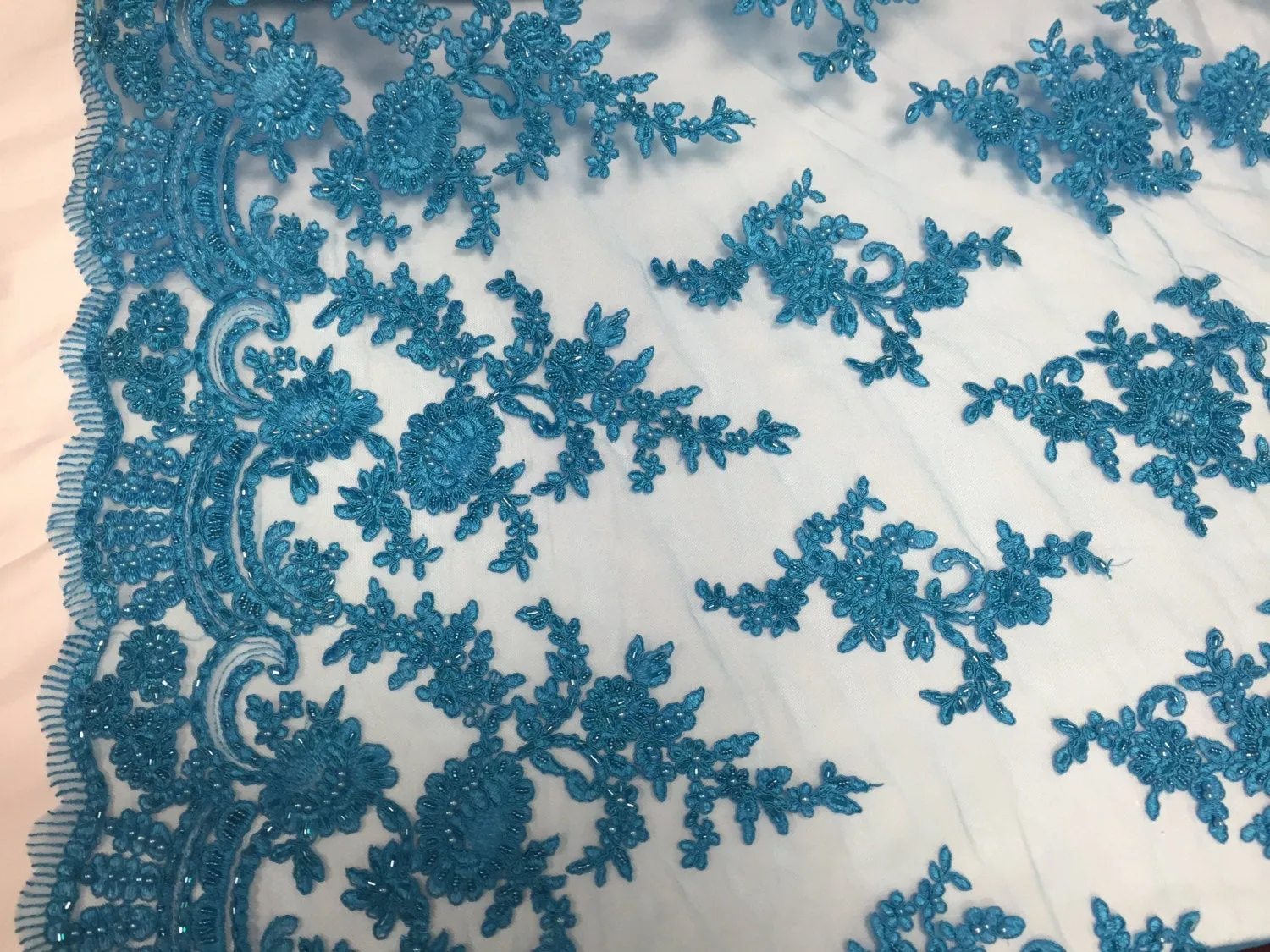 Turquoise appwaling flower design emboider and beaded on a mesh lace-prom-nightgown-decorations-dresses-sold by the yard.